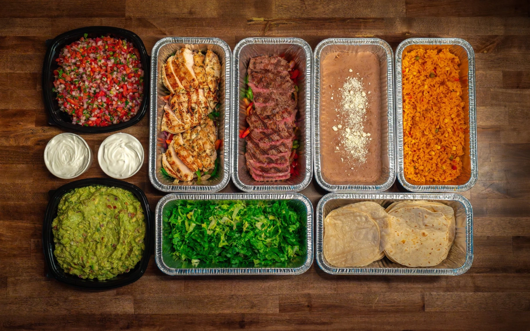 Sol Agave Mexican catering spread with tacos, rice, beans, guacamole and salsas