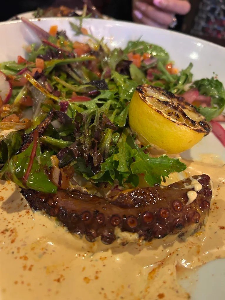 Grilled pulpo with citrus and herbs